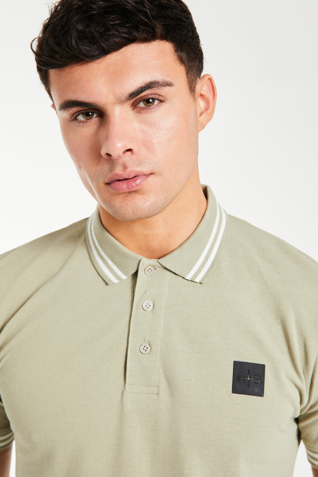 Close up of men's polo shirts sale in green with ''Avant Garde Paris' logo