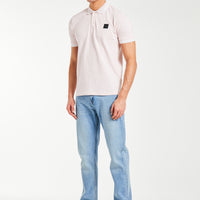 Cheap polo shirts in light pink styled with jeans