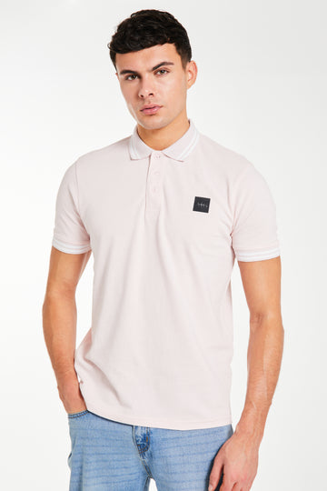 model wearing light pink men's polo shirts sale and white trim