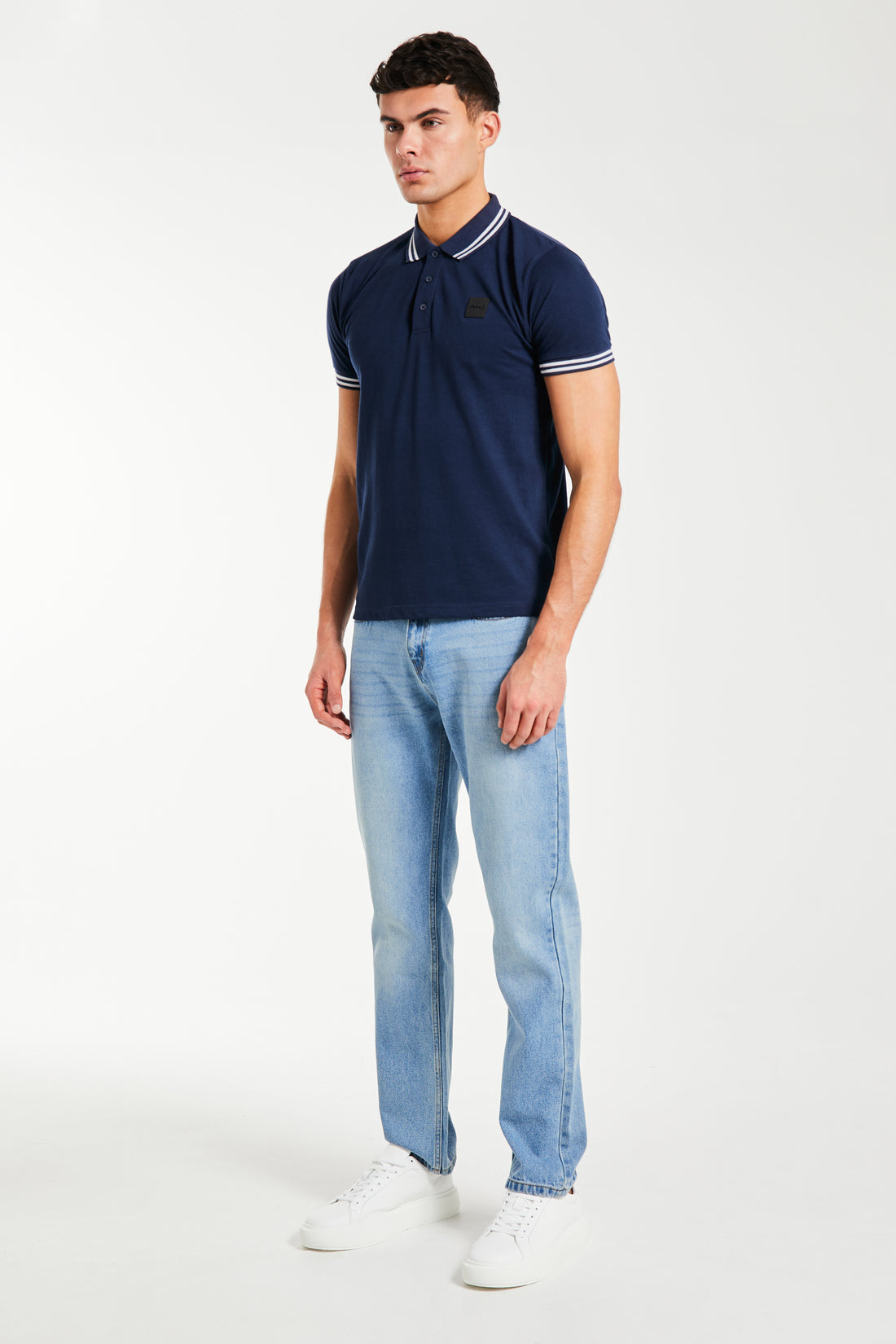 side profile of navy blue men's polo shirts sale styled with jeans