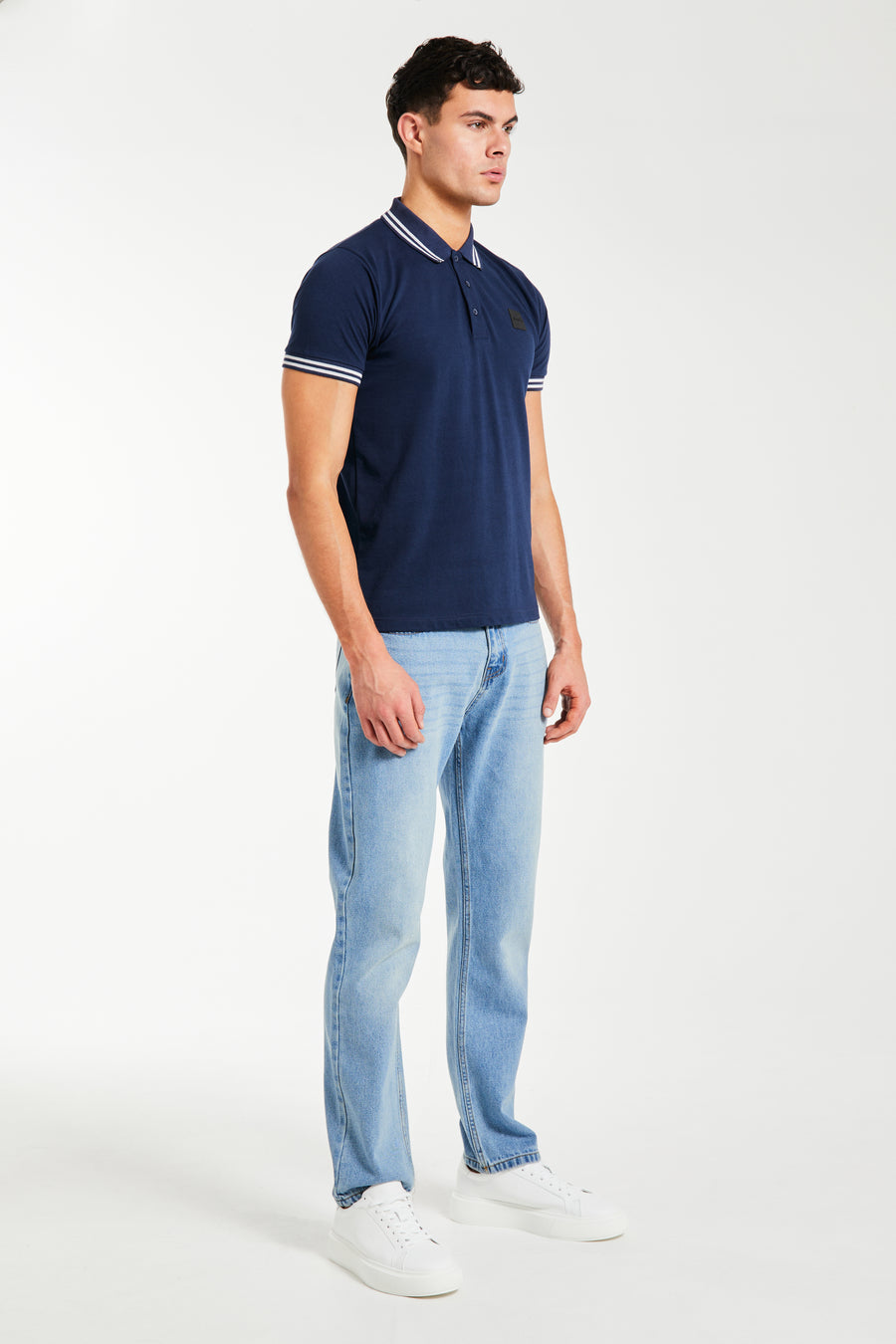 Cheap polo shirts in dark blue and white trim styled with jeans