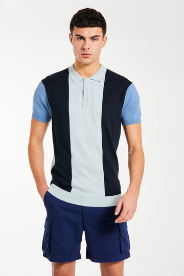 Model wearing striped men's knitted polo with shors