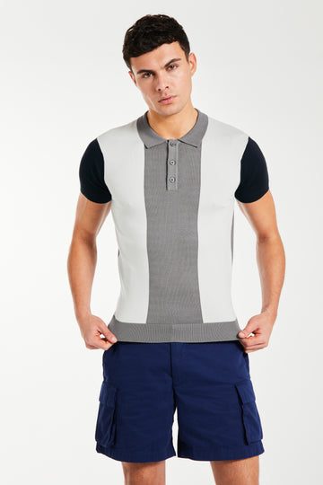 Model wearing men's knitted polo in block colours grey, white and black