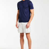 men's knitted polo with button up feature in dark blue styled with shorts