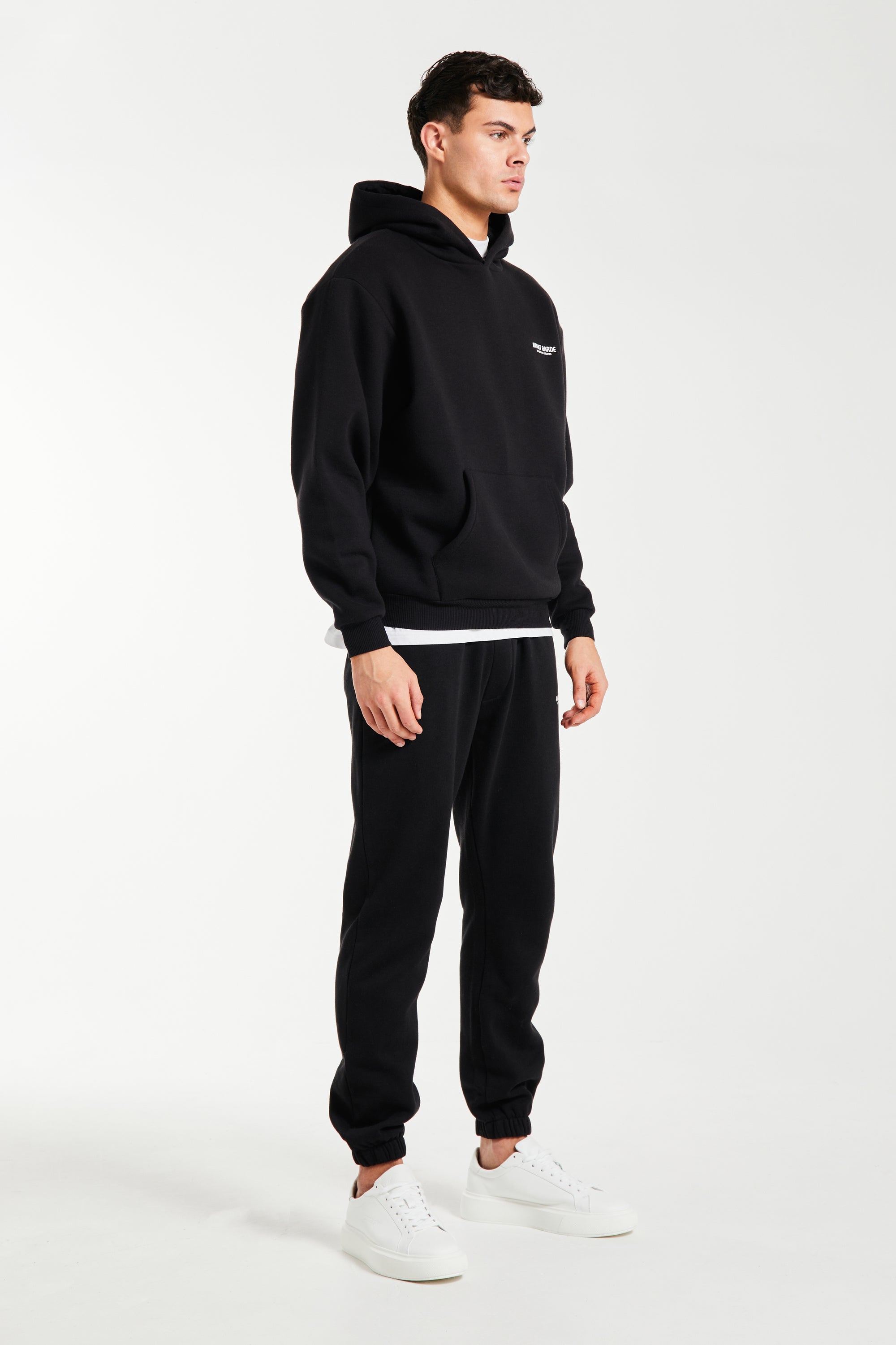 Side profile of mens tracksuit in black