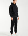 Side profile of mens tracksuit in black