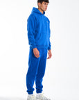 Model wearing royal blue tracksuit