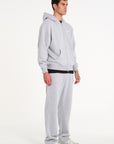 Model facing to the right wearing full grey tracksuit