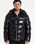 Model wearing black hooded puffer jacket