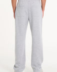 Backshot of model wearing grey tracksuit bottoms