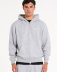 Model wearing zip up hoodie in grey