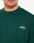 Close up shot of Avant Garde logo on green crew neck T-shirt