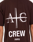 Close up backshot of brown crew neck T-shirt with Avant Garde logo on the back