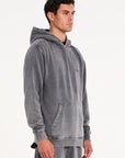 Model facing to the right wearing men's hoodie in steel
