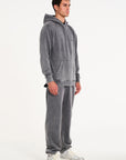 Model facing to the right wearing matching hoodie and tracksuit bottoms in steel