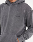 Front of Avant Garde hoodie in steel with hands in pocket