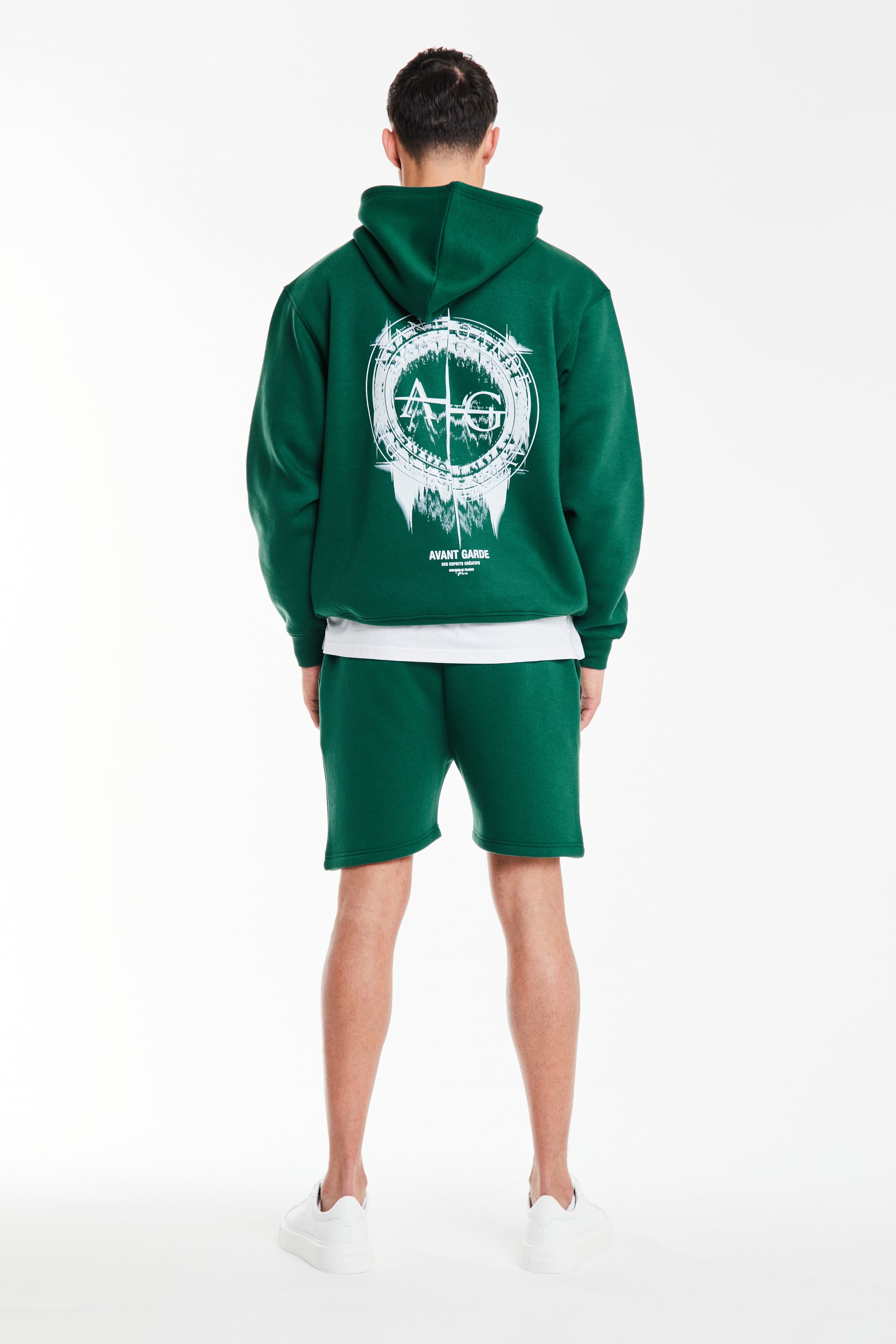 back profile of mens coord in green with logo on back