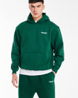 model wearing emerald green hoodie