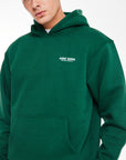 close up of hoodie in forest green with logo on chest