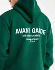 close up of 'Avant Garde' logo on back of mens hoodies in dark green