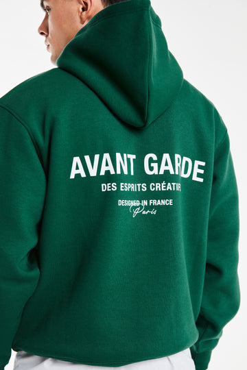 close up of 'Avant Garde' logo on back of mens hoodies in dark green