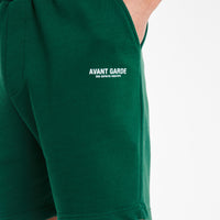 close up of 'avant garde paris' logo on emerald green jersey shorts