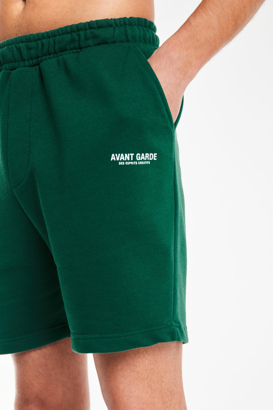 close up of 'avant garde paris' logo on emerald green jersey shorts