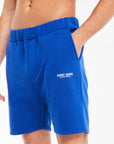 close up of royal blue men's jersey shorts sale with 'avant garde paris' logo