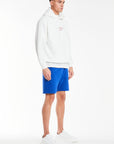 White men's hoodie with cuffed sleeves styled with shorts