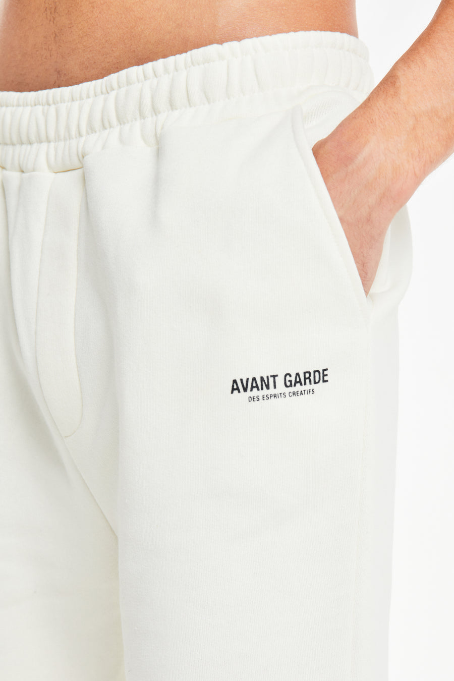 close up of 'Avant Garde Paris' logo on off white jersey shorts