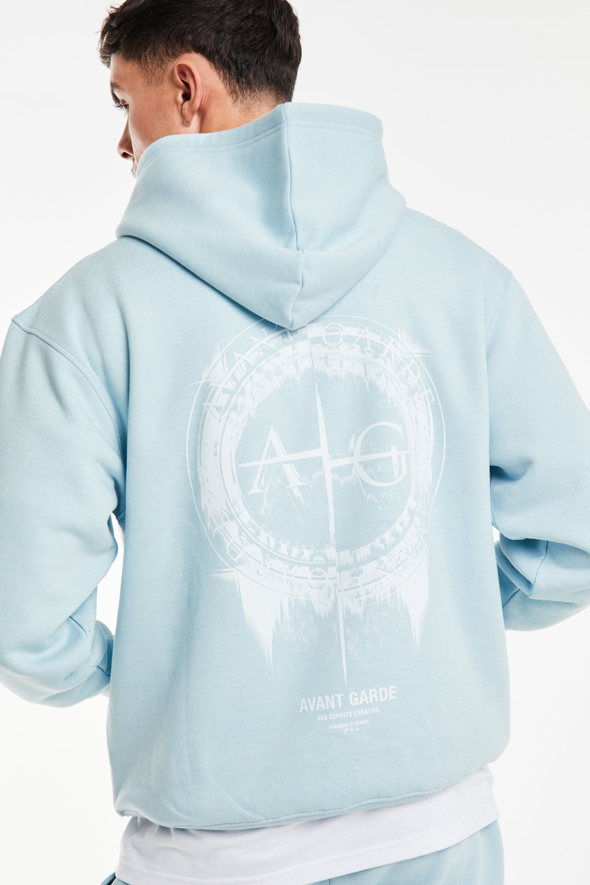 back profile of blue men twin set hoodie showing 'Avant Garde' logo