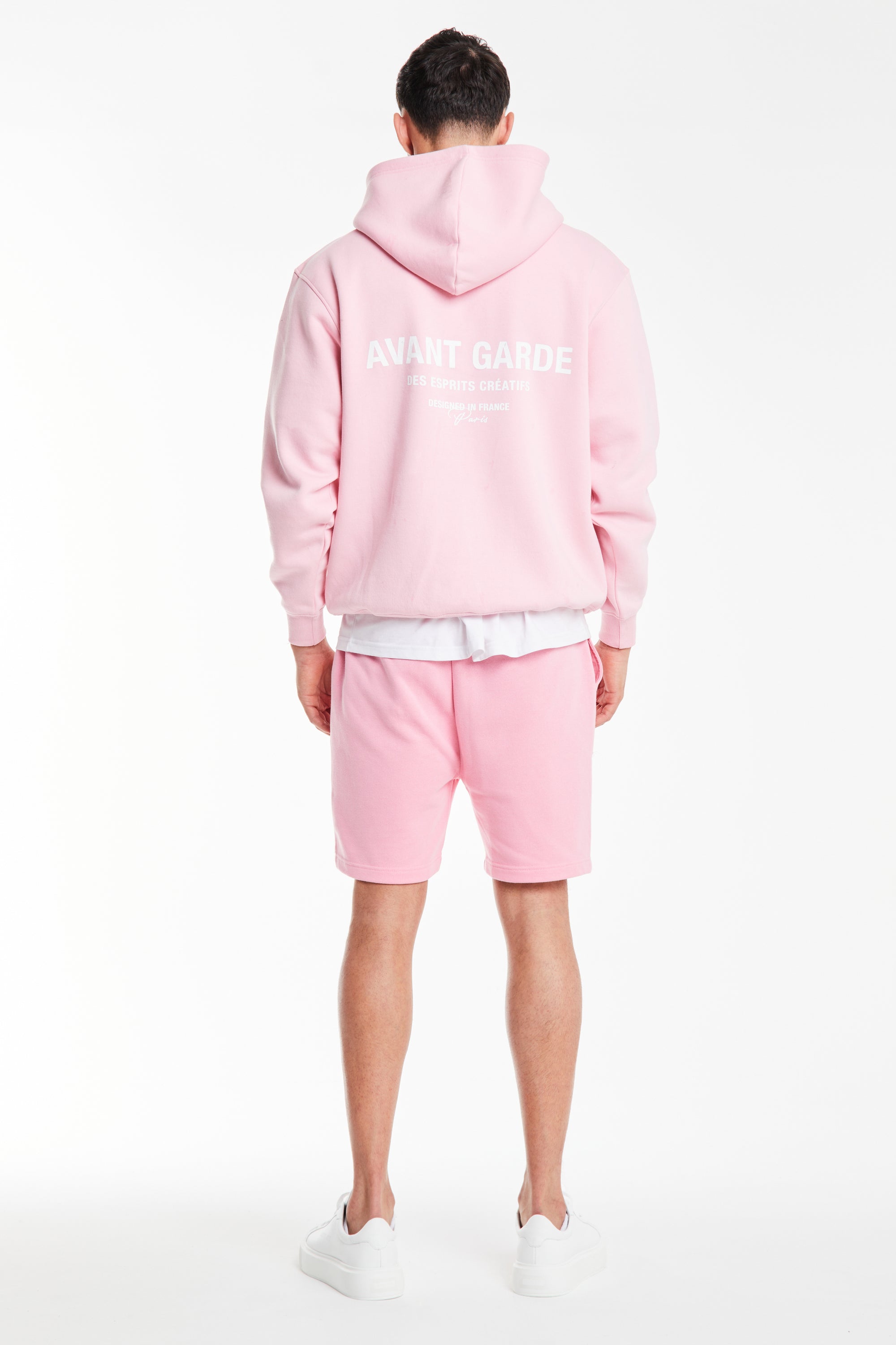 back profile of light pink men's hoodies sale with 'avant garde' logo