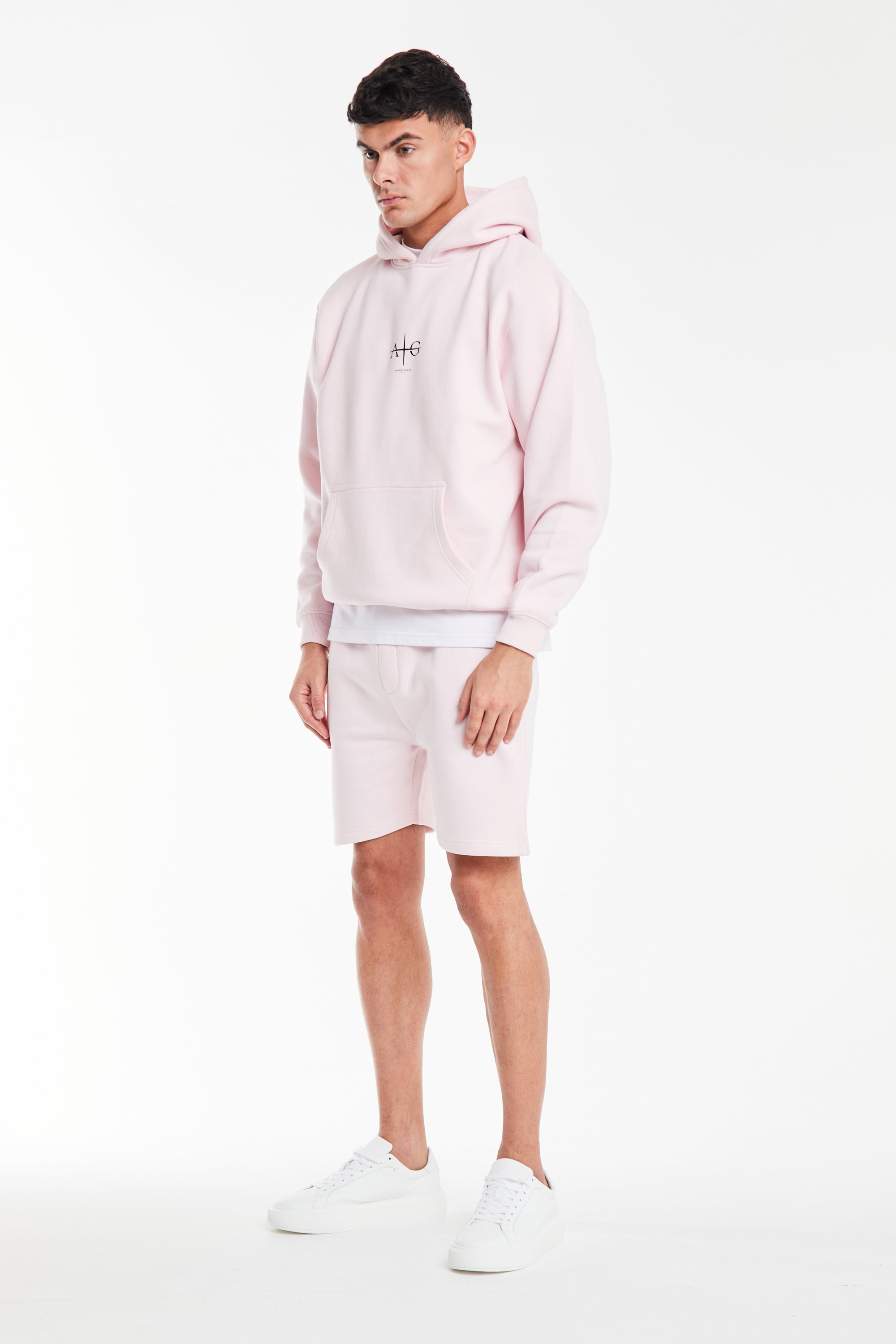 Model wearing a men's coord set in light pink