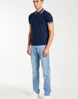 side profile of navy blue men's polo shirts sale styled with jeans