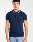 Model wearing men's polo shirts sale in navy blue with white trim 