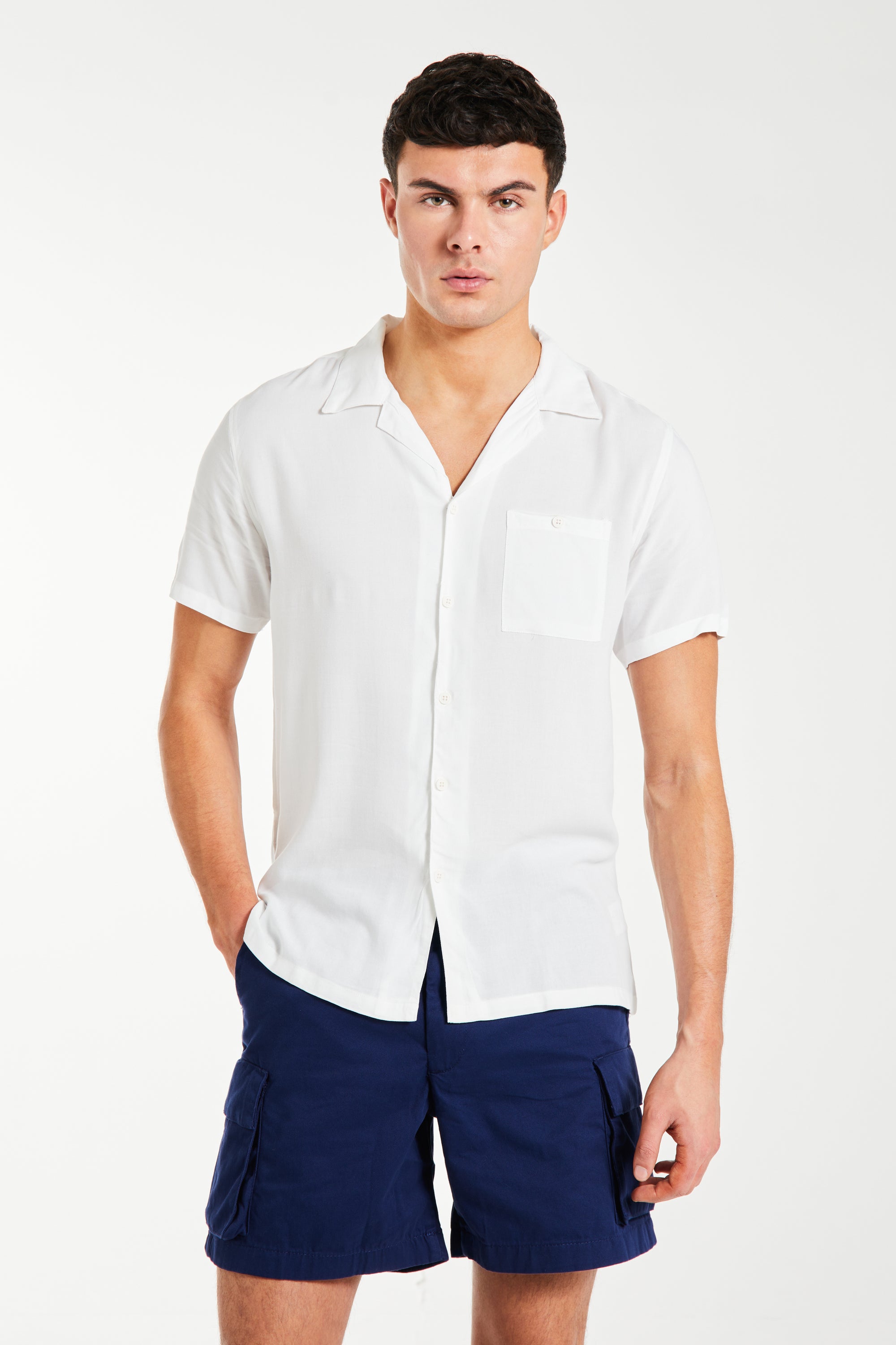 model wearing men's utility shorts with white shirt