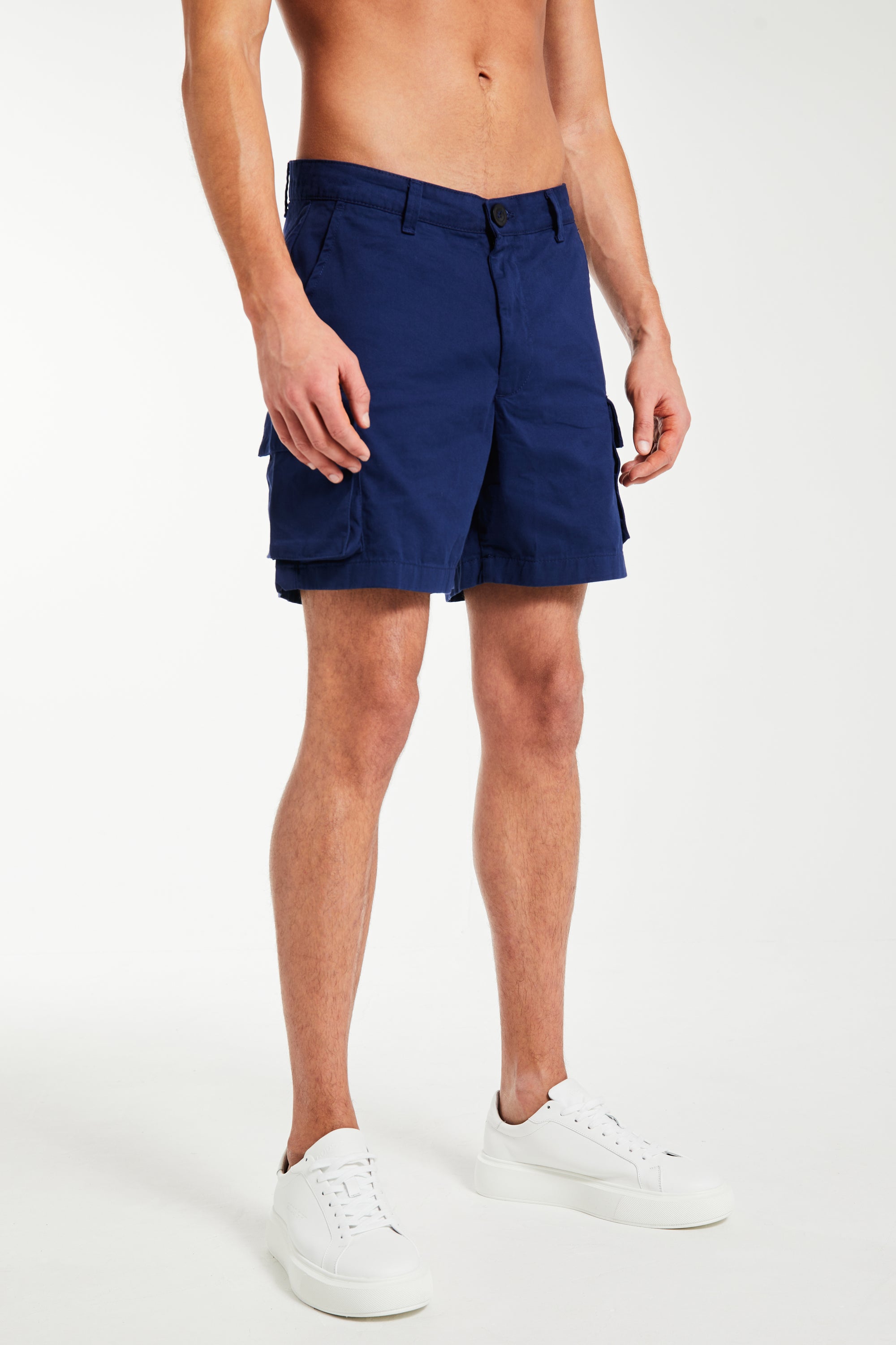 dark blue men&#39;s utility shorts paired with trainers