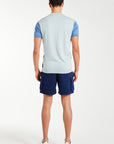 Back profile of blue men's knitted polo and shorts