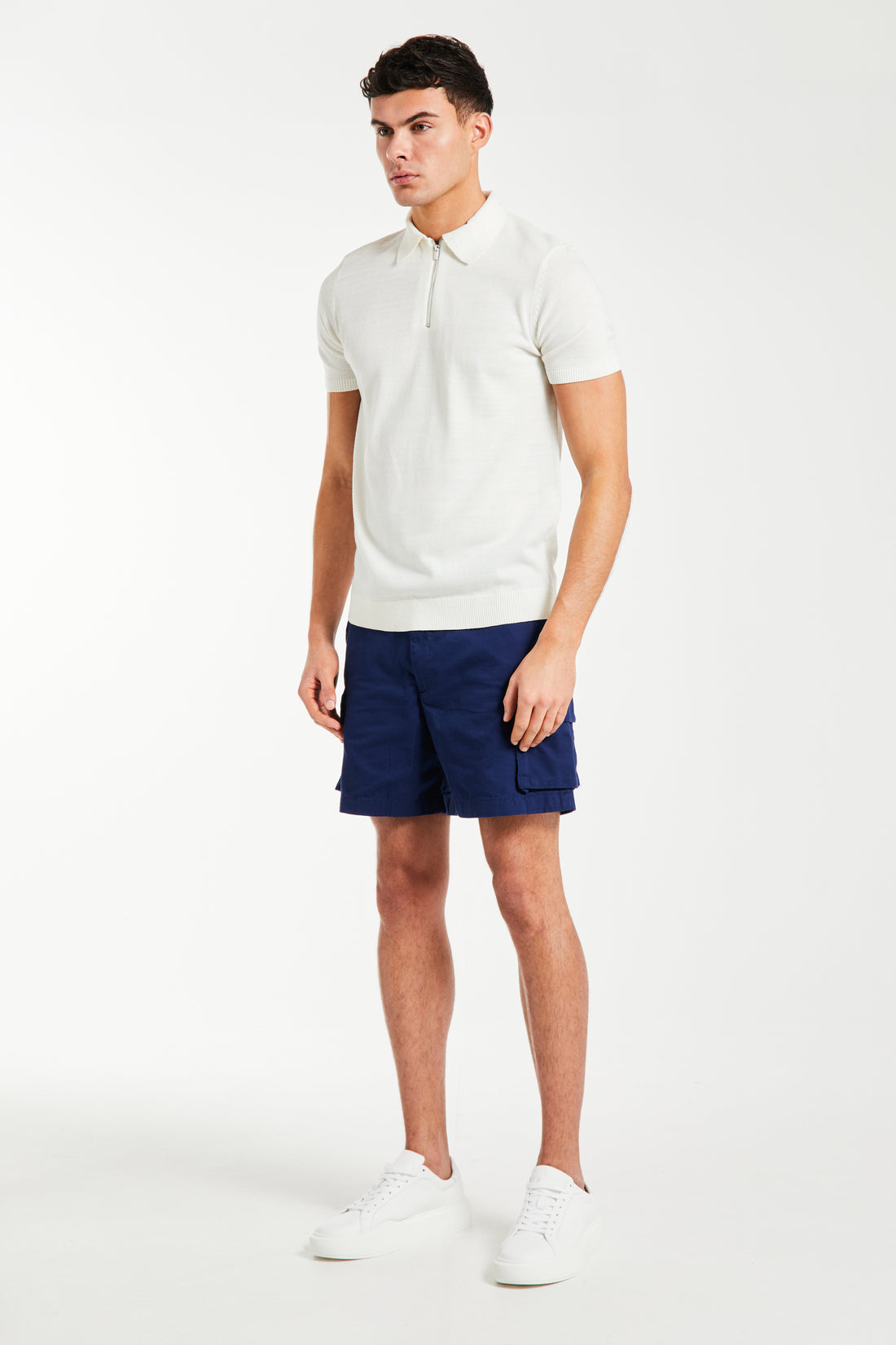 men's knitwear polo in cream styled on male model with shorts