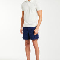 men's knitwear polo in cream styled on male model with shorts