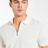 close up of men's zip knitted polo in ecru