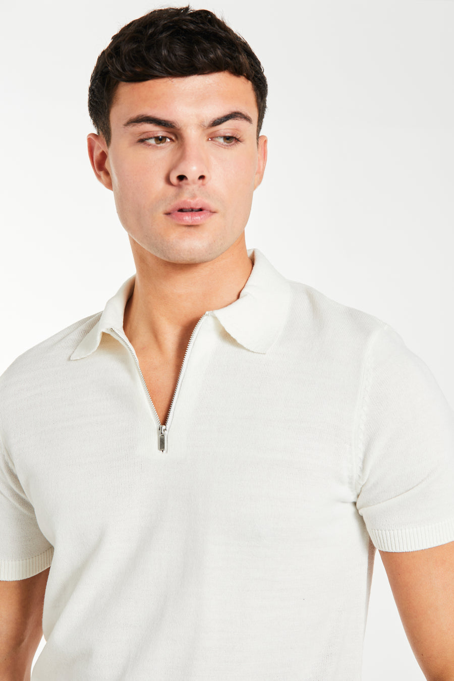 close up of men's zip knitted polo in ecru