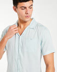 close up of  men's collard shirt in light blue