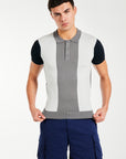 Model wearing men's knitted polo in block colours grey, white and black