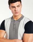 close up of button up block men's knitted polo in dark grey