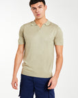 Model wearing v-neck knitted polo in oatmeal