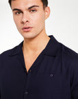 Close up of men's collared shirt in dark navy blue