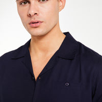 Close up of men's collared shirt in dark navy blue
