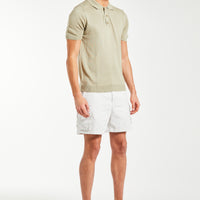 Oatmeal knitted polo on male model styled with shorts