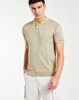 model wearing 'Senza' knitted polo in light beige with shorts
